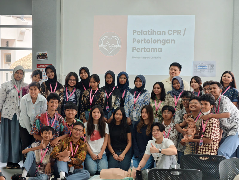 Students and the Beatkeepers team pose together after a CPR awareness workshop